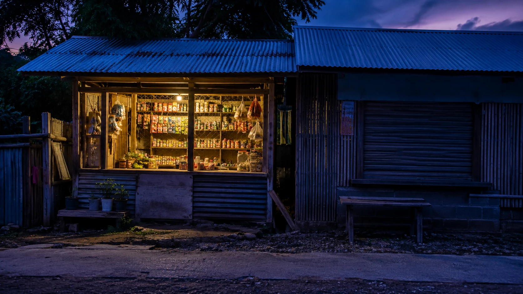 A lit store beside a darkened, closed neighbouring stall
