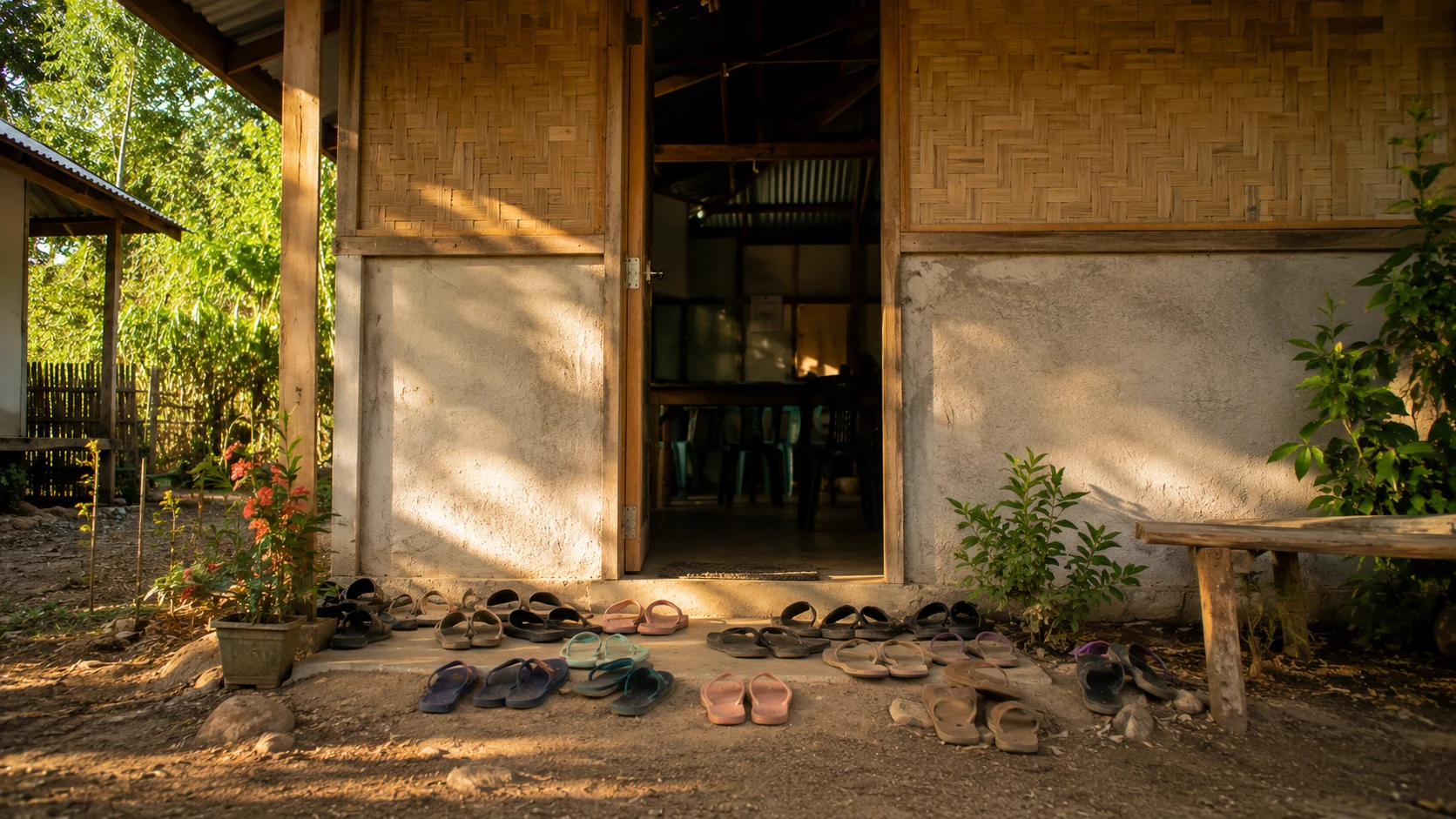 A doorway with sandals lined up outside, suggesting a meeting inside