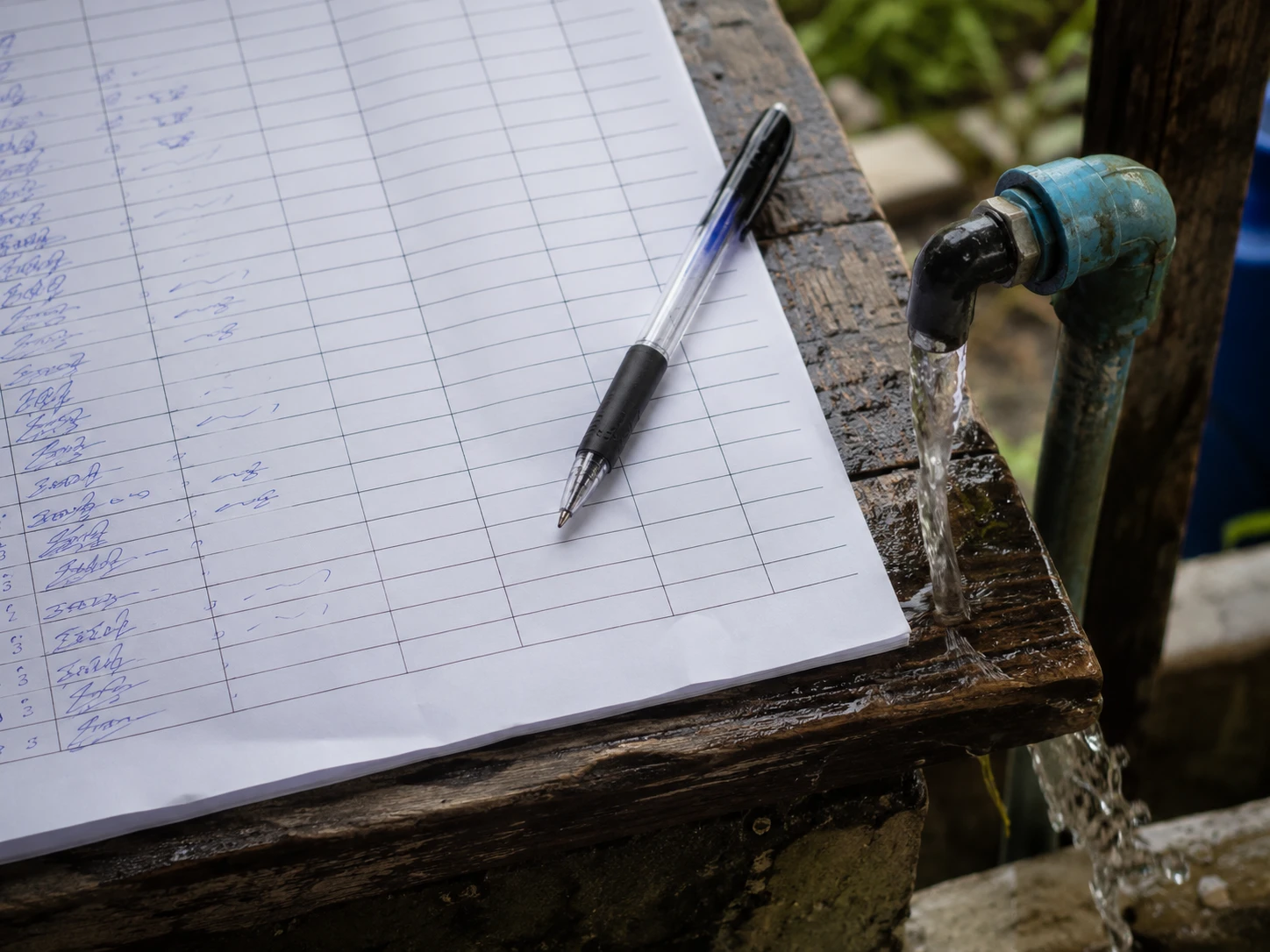 A reading form resting beside a water collection pipe